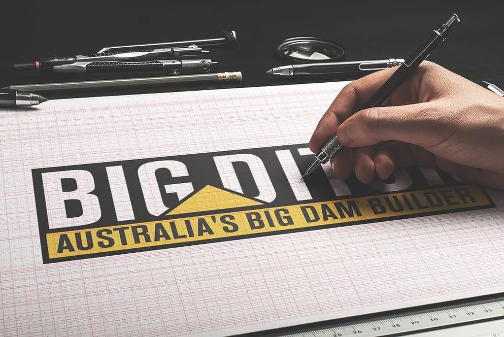 Hand drawing a logo that reads "BIG DITCH: AUSTRALIA'S BIG DAM BUILDER" on grid paper, with drawing tools nearby.